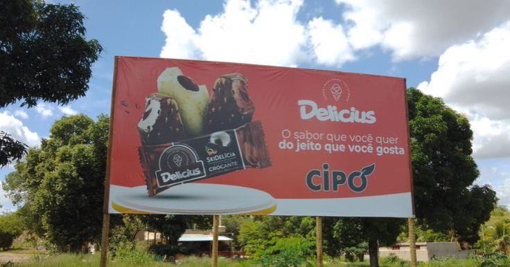 Lona de outdoor impressa para a sorveteria Delicius, instalada à beira da estrada